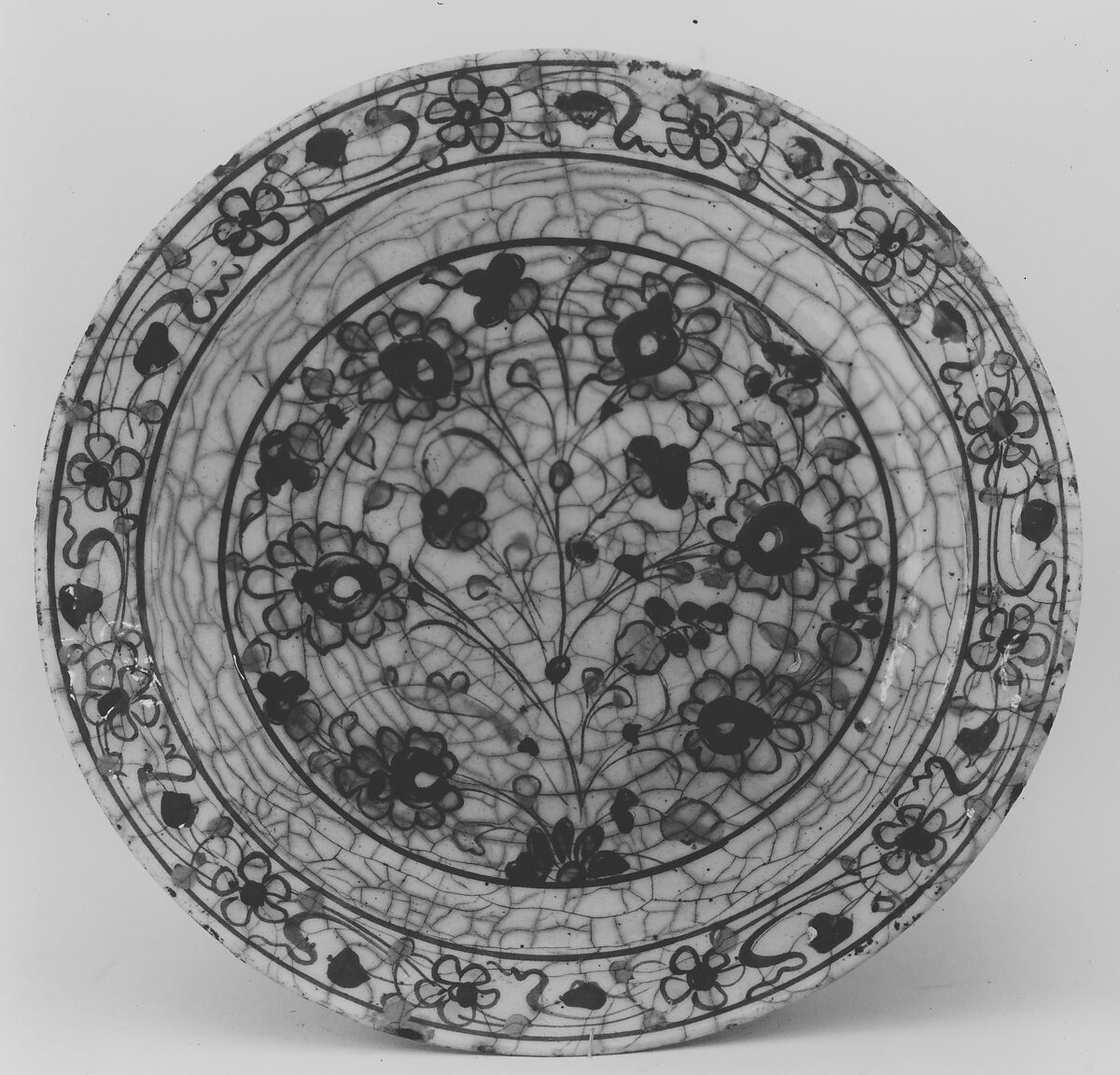 Dish, Stonepaste; underglaze painted in black and green with red and yellow slips