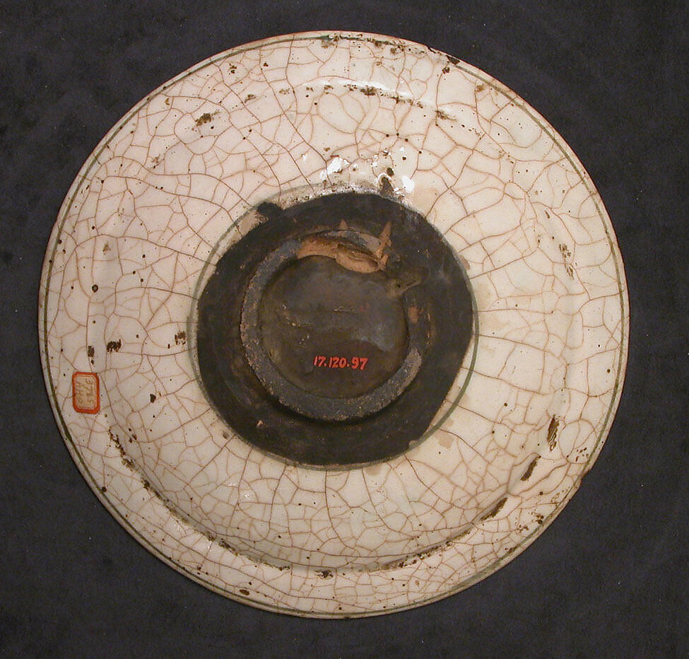 Dish, Stonepaste; underglaze painted in black and green with red and yellow slips