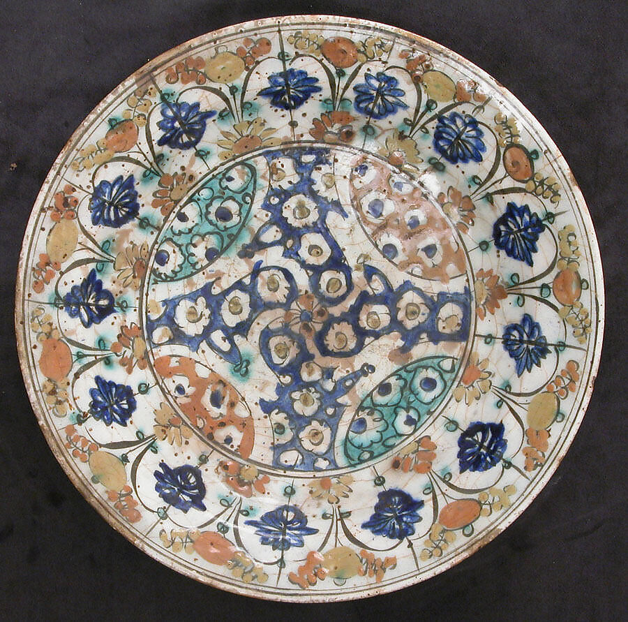 Dish, Stonepaste; underglaze painted in black, blue, and green with red and yellow slips 