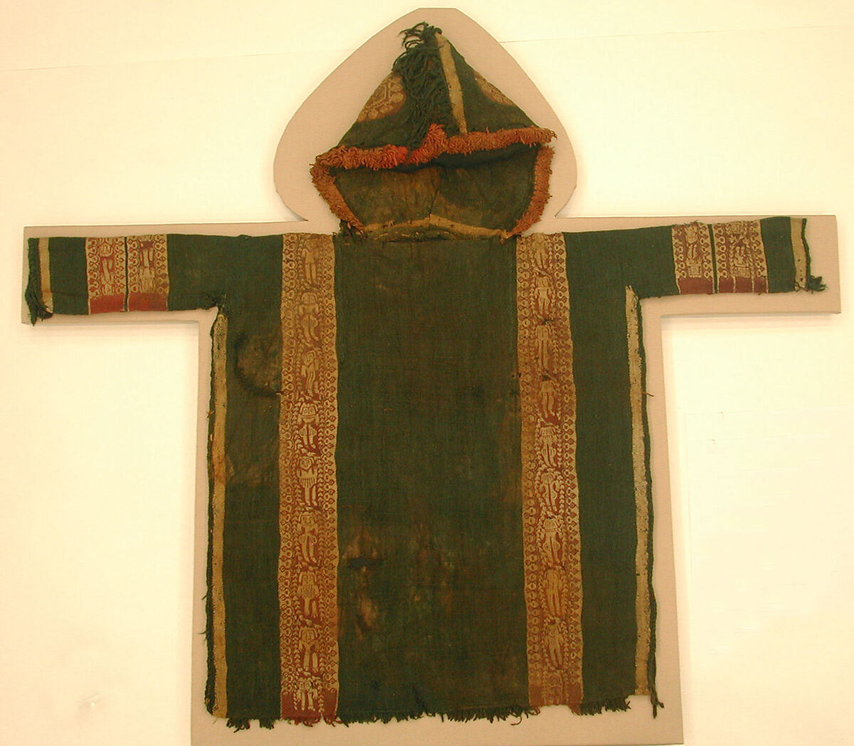 Child's Tunic with Hood, Tapestry weave in purple-colored, red-brown, and undyed wool on plain-weave ground of green wool; fringes in green and red-brown along the perimeter of the hood and lower edges