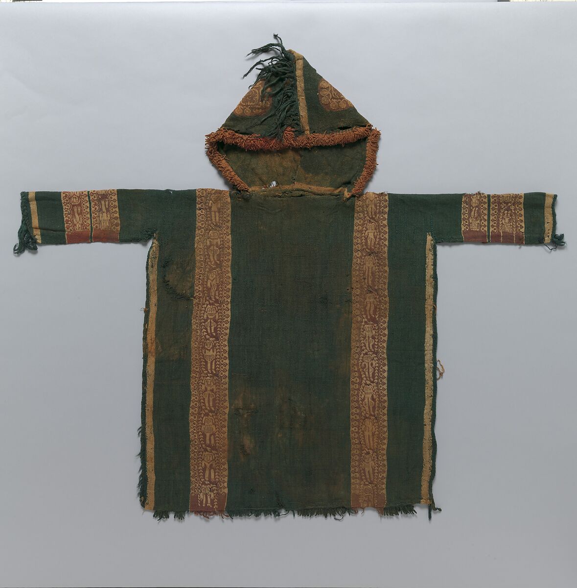 Child's Tunic with Hood, Tapestry weave in purple-colored, red-brown, and undyed wool on plain-weave ground of green wool; fringes in green and red-brown along the perimeter of the hood and lower edges 