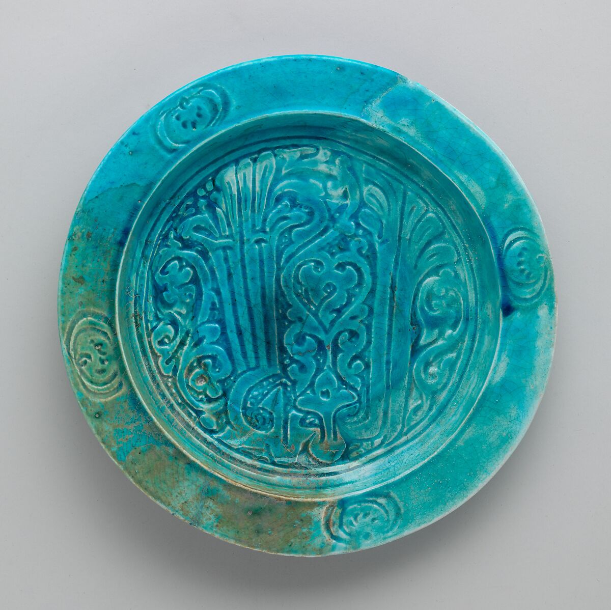 Dish with Carved Arabic Inscription in Floriated Kufic Reading "al-'izz" ("Glory"), Stonepaste; carved and glazed 