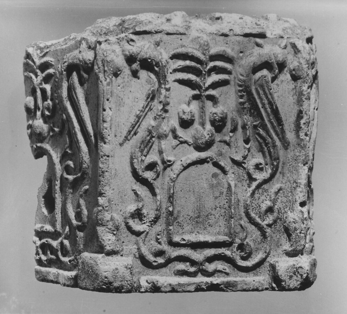 Fragment of a Base with Pair of Peacocks flanking a Palm Motif, Stucco; molded