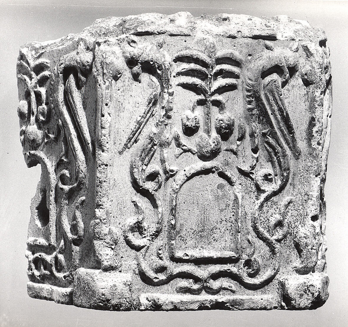 Fragment of a Base with Pair of Peacocks flanking a Palm Motif, Stucco; molded