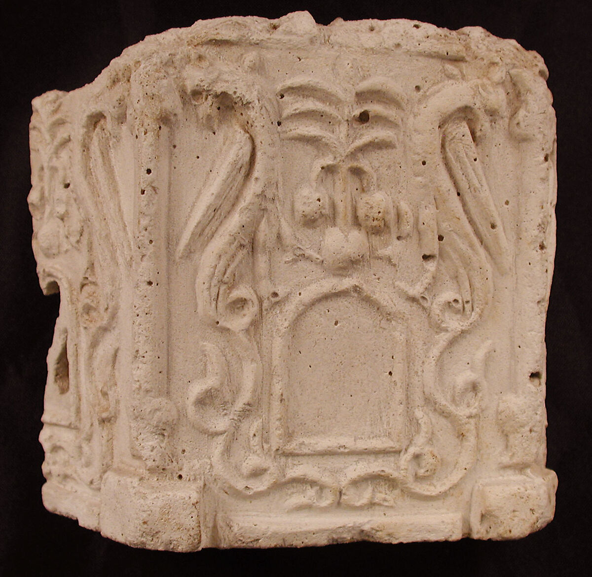 Fragment of a Base with Pair of Peacocks flanking a Palm Motif, Stucco; molded 