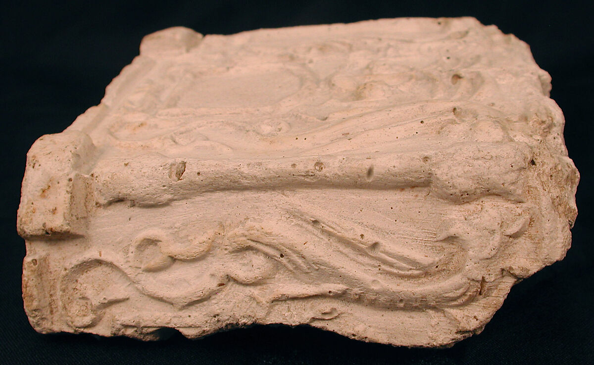 Fragment of a Base with Pair of Peacocks flanking a Palm Motif, Stucco; molded