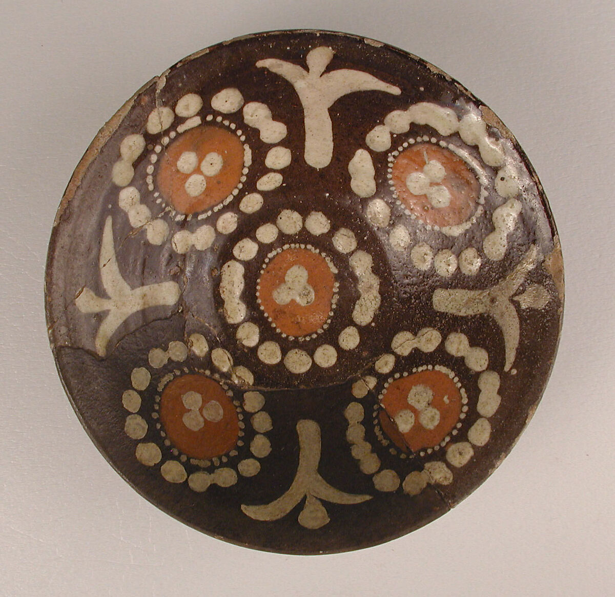 Bowl, Earthenware; brown slip with polychrome slip decoration under transparent glaze 