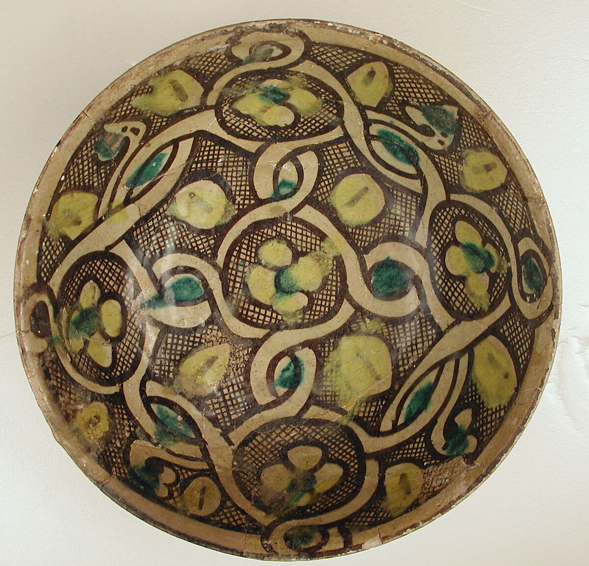 Bowl with Interlace Pattern and Yellow Flowers, Earthenware; polychrome decoration under transparent glaze (buff ware)