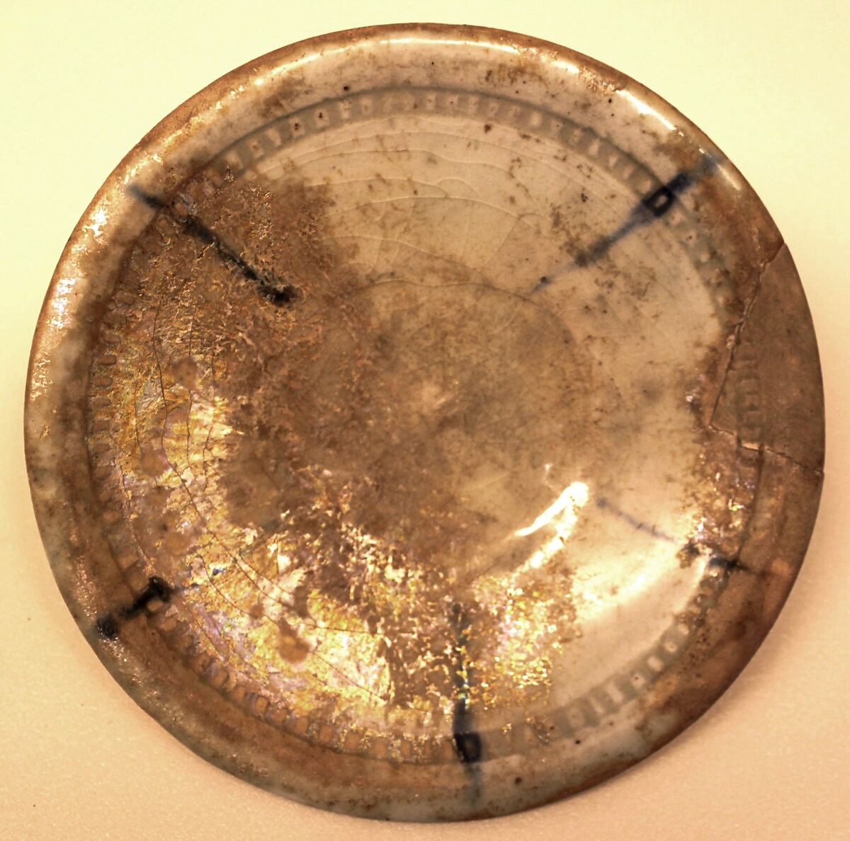 Dish, Stonepaste; colorless, iridescent glaze; gritty, white,body; restored. 