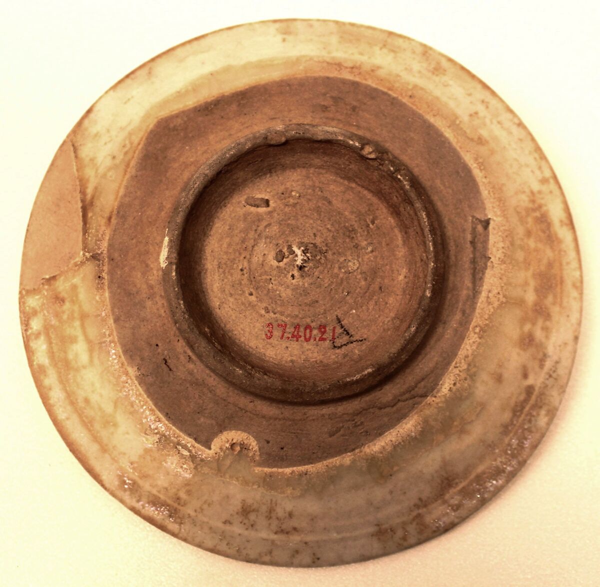 Dish, Stonepaste; colorless, iridescent glaze; gritty, white,body; restored.