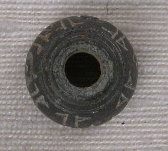 Button, Stone; incised and inlaid with paint