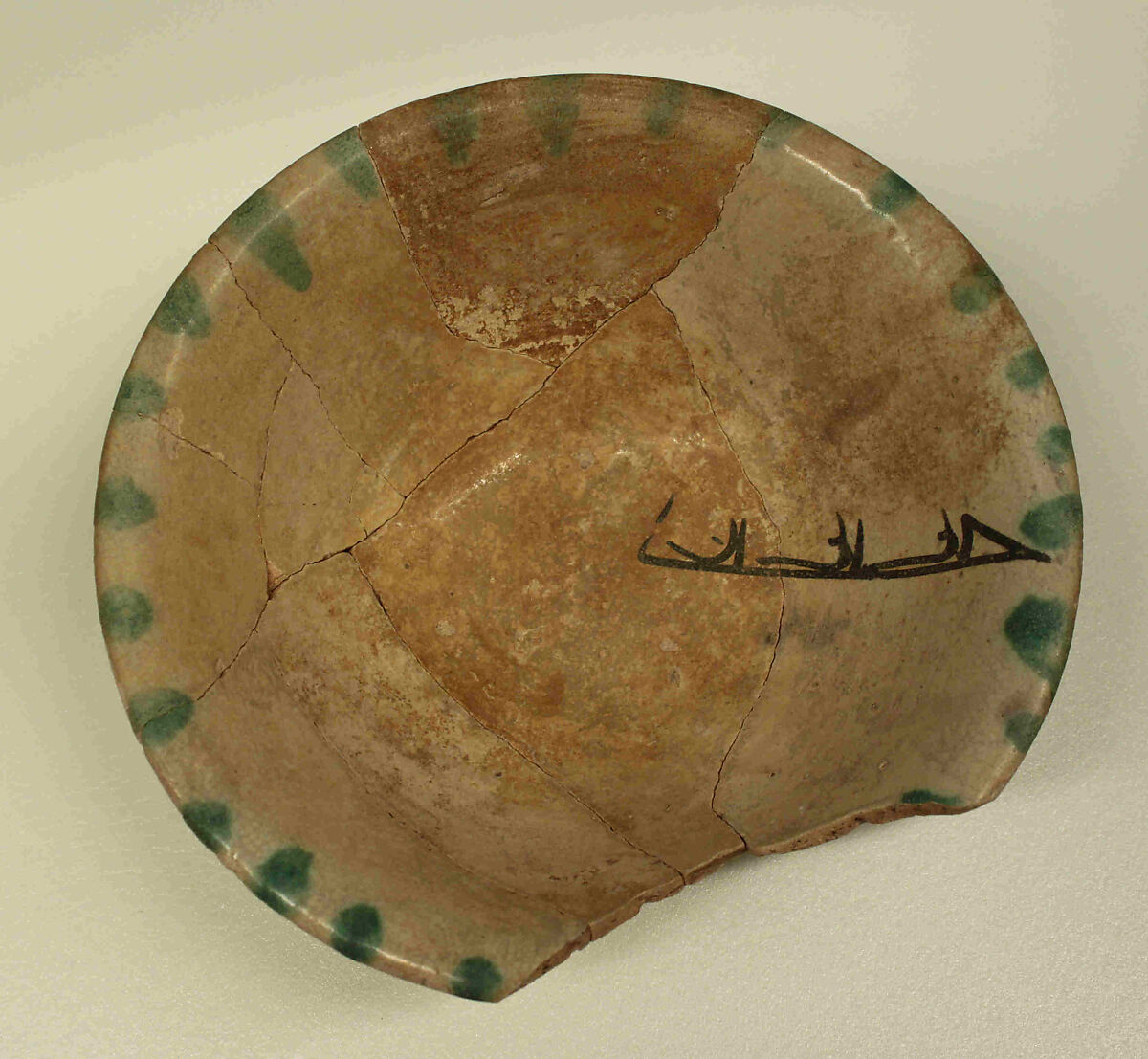 Bowl with Inscription, Earthenware; painted in black with splashes of green on opaque white (tin) glaze 