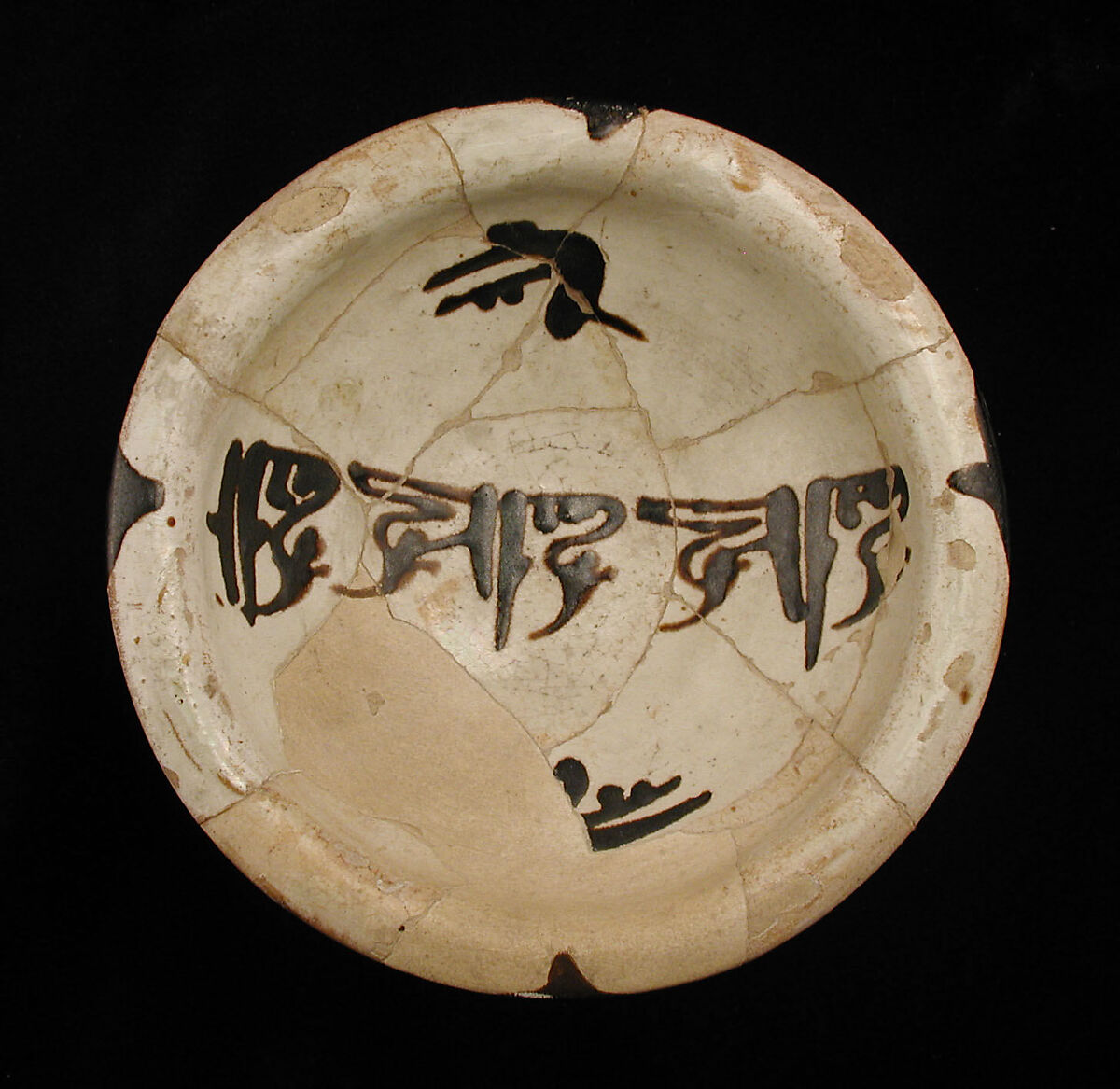 Three Bowls with Floriated Kufic Inscriptions, Earthenware; white slip with black slip decoration under transparent glaze