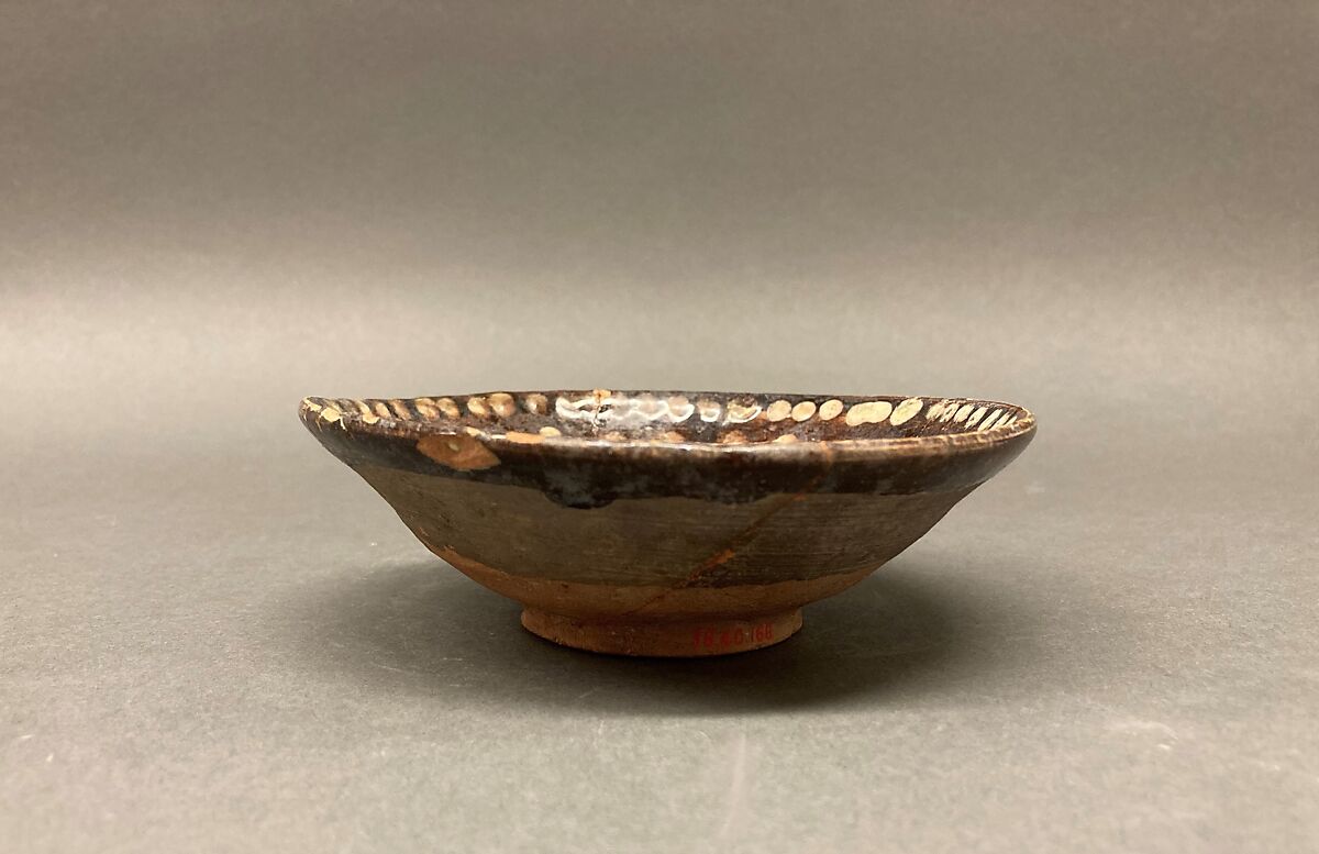 Bowl, Earthenware; brown slip covered with slip decoration under transparent greenish glaze