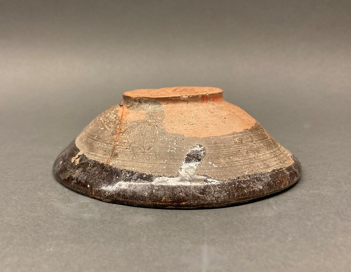 Bowl, Earthenware; brown slip covered with slip decoration under transparent greenish glaze