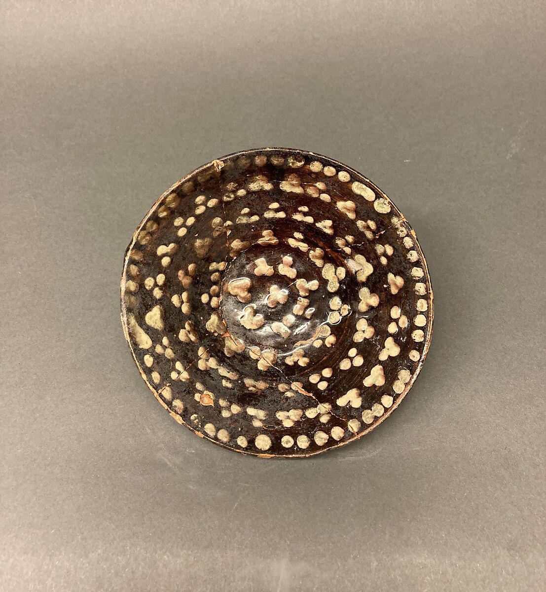 Bowl, Earthenware; brown slip covered with slip decoration under transparent greenish glaze