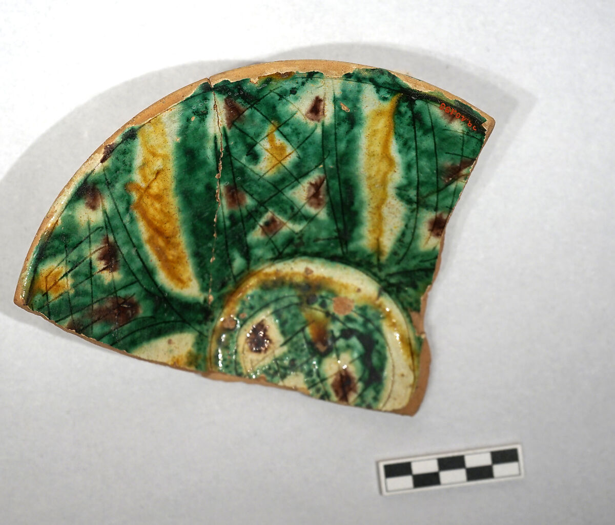 Fragment of a Bowl, Earthenware; white slip with polychrome slip decoration under transparent greenish glaze, incised