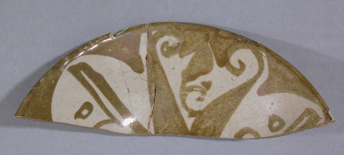 Fragment of a Bowl, Earthenware; luster-painted on opaque white glaze 
