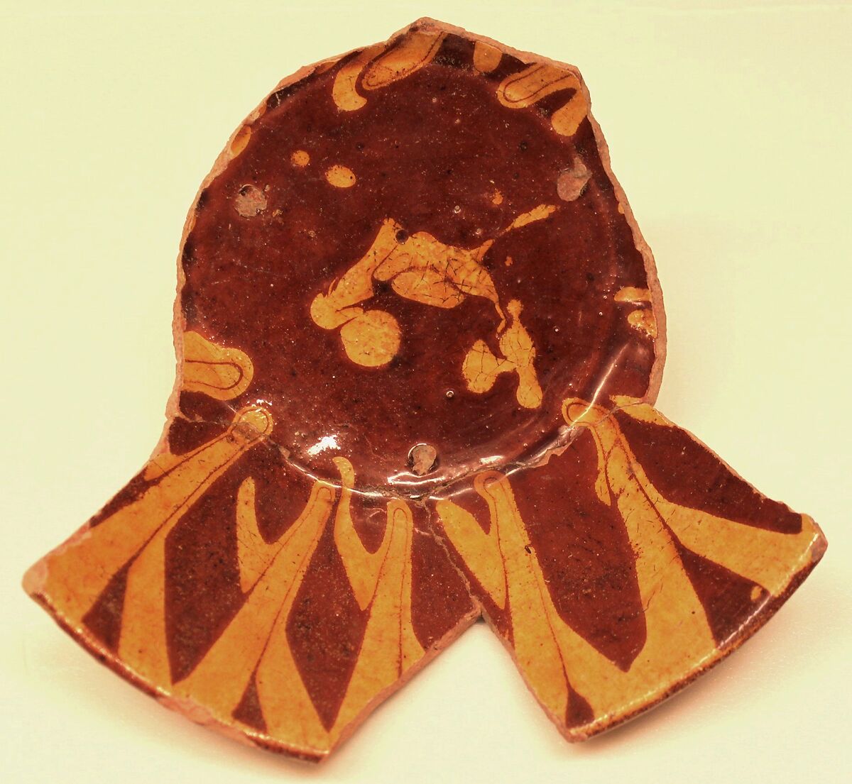 Fragment of a Bowl, Earthenware; red and yellow slip decoration under transparent glaze 