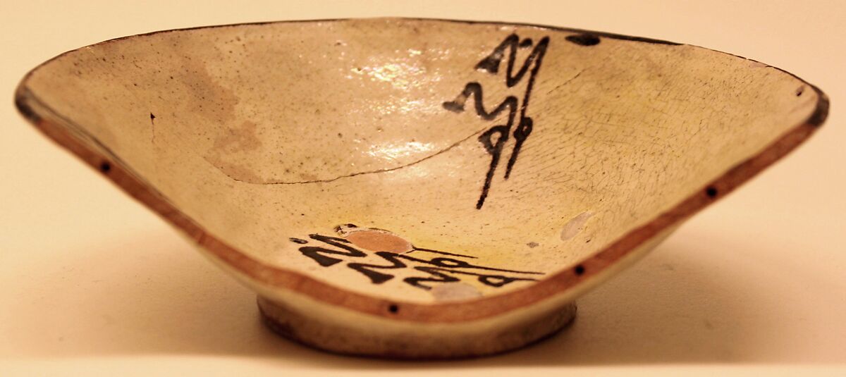 Bowl, Earthenware; white slip, decoration in brown-black and glaze tinged with yellow