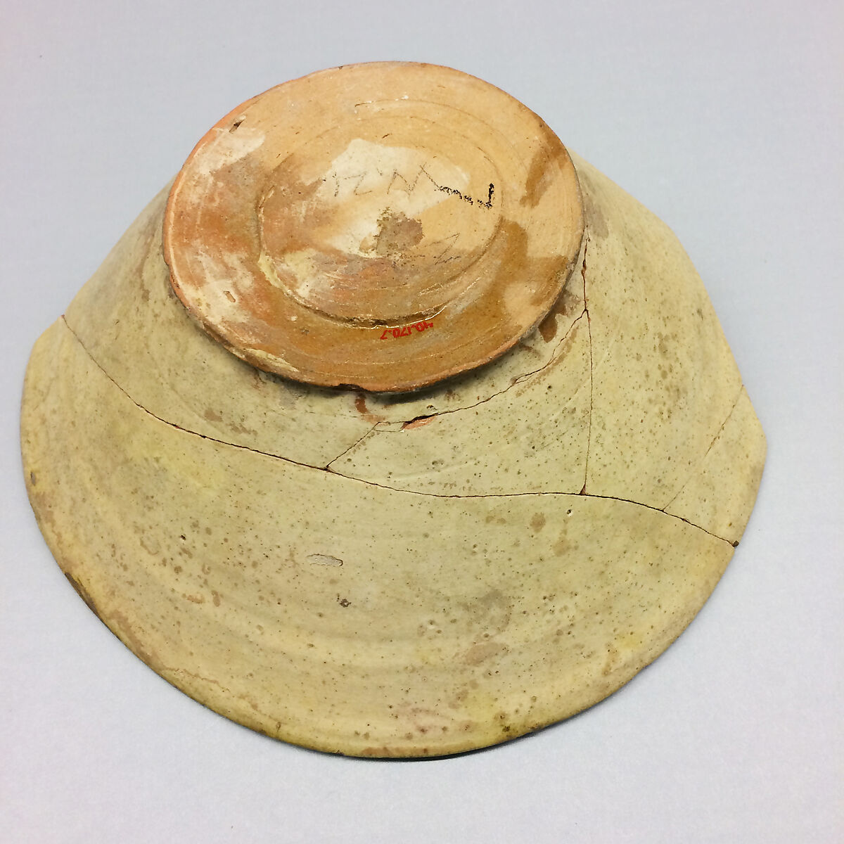 Bowl, Earthenware; white slip, black decoration tinges the glaze yellow