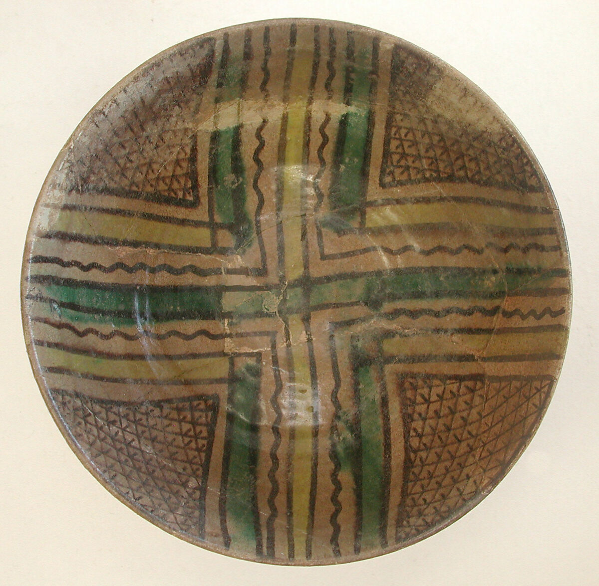 Bowl, Earthenware; buff slip, underglaze painted in black slip and polychrome pigments under transparent glaze