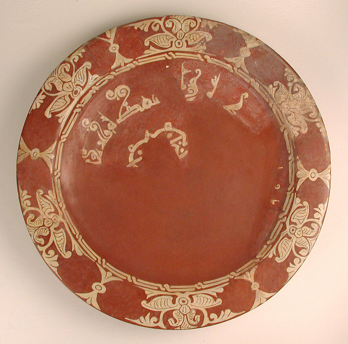 Plate, Earthenware; slip-covered, with monochrome slip decoration under transparent glaze 