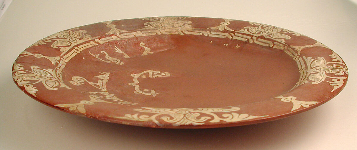 Plate, Earthenware; slip-covered, with monochrome slip decoration under transparent glaze
