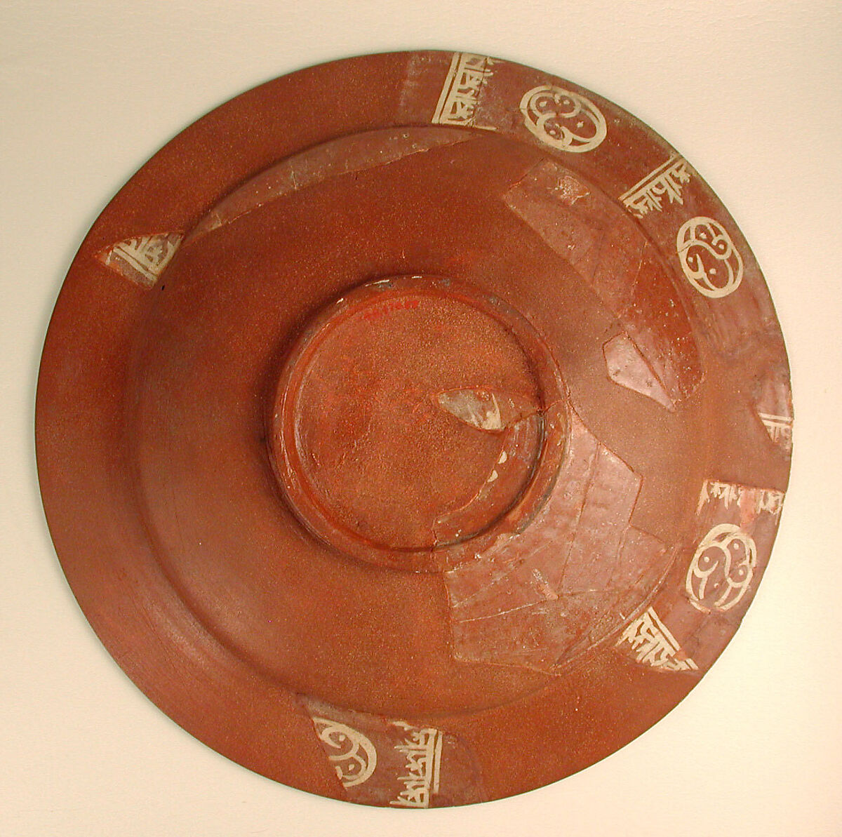 Plate, Earthenware; slip-covered, with monochrome slip decoration under transparent glaze