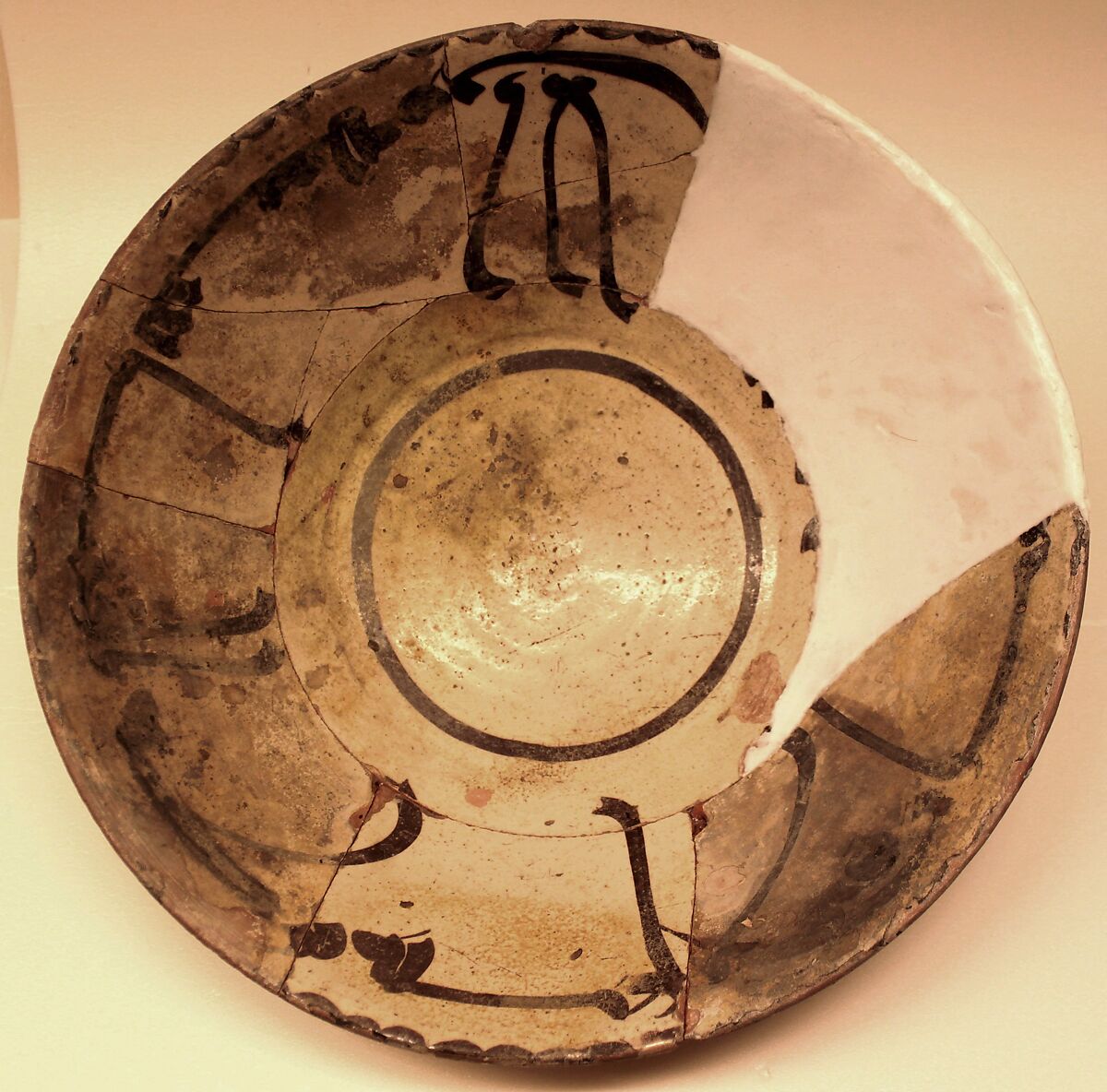 Bowl, Earthenware; white slip, decoration in purplish black, glazed 