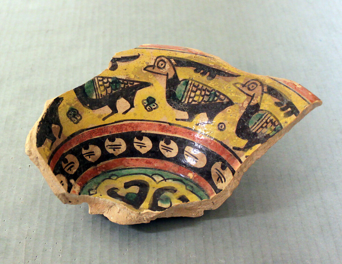 Fragment of a Bowl, Earthenware; buff slip, decoration in black with touches of red, green and bright yellow 