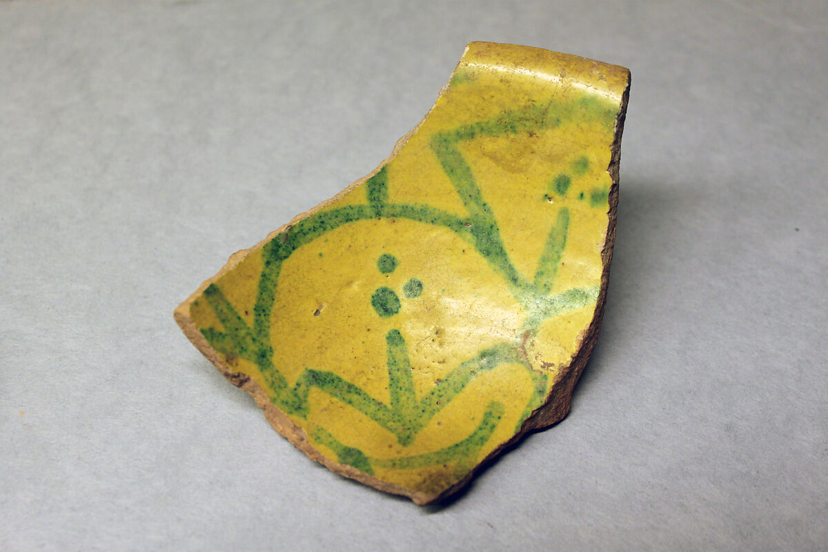 Fragment of a Bowl, Earthenware; buff slip, opaque yellow glaze, green decoration, glazed 