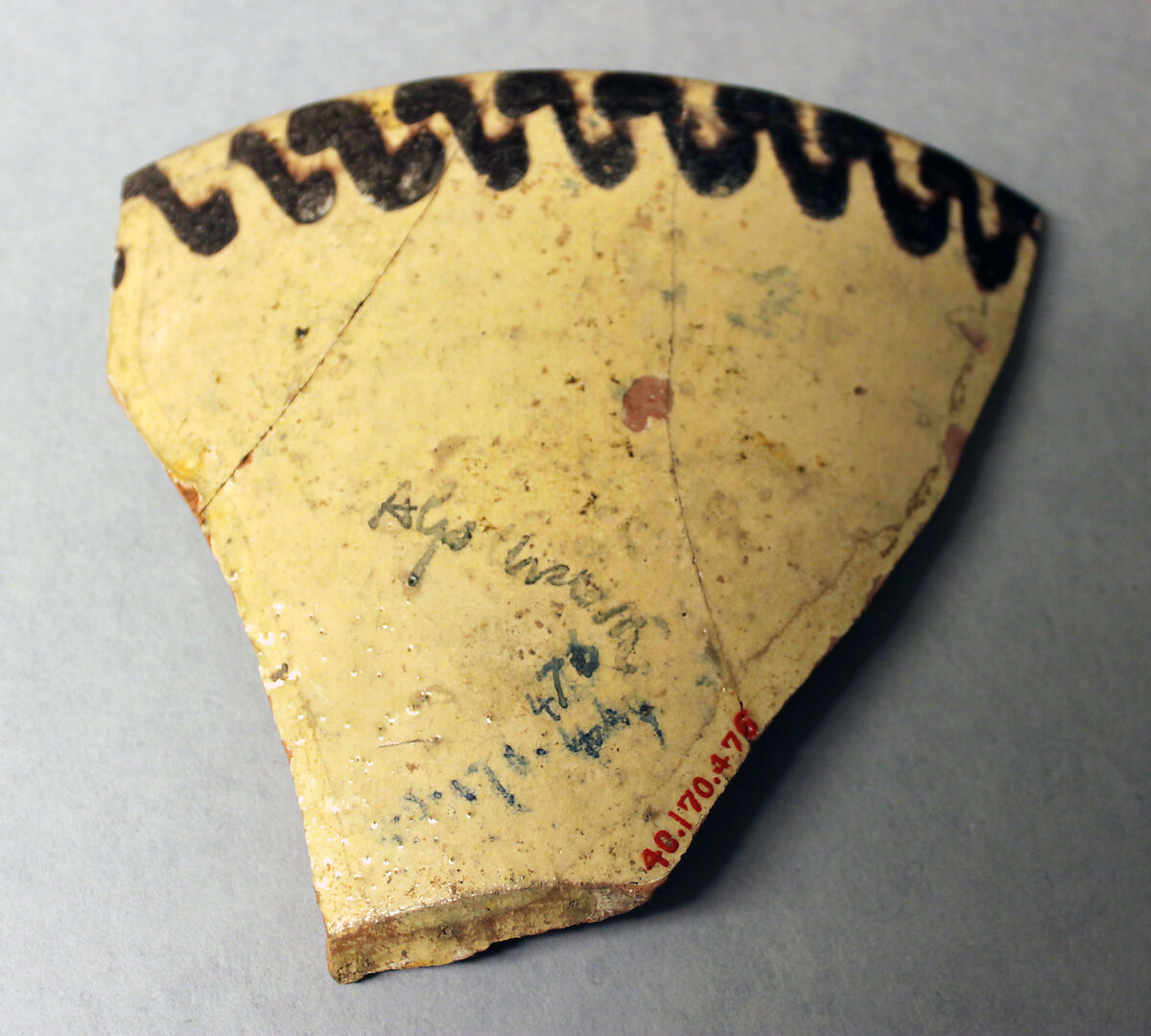 Fragment of a Bowl, Earthenware; red body, white slip with manganese brown, red and yellow-black decoration under glaze