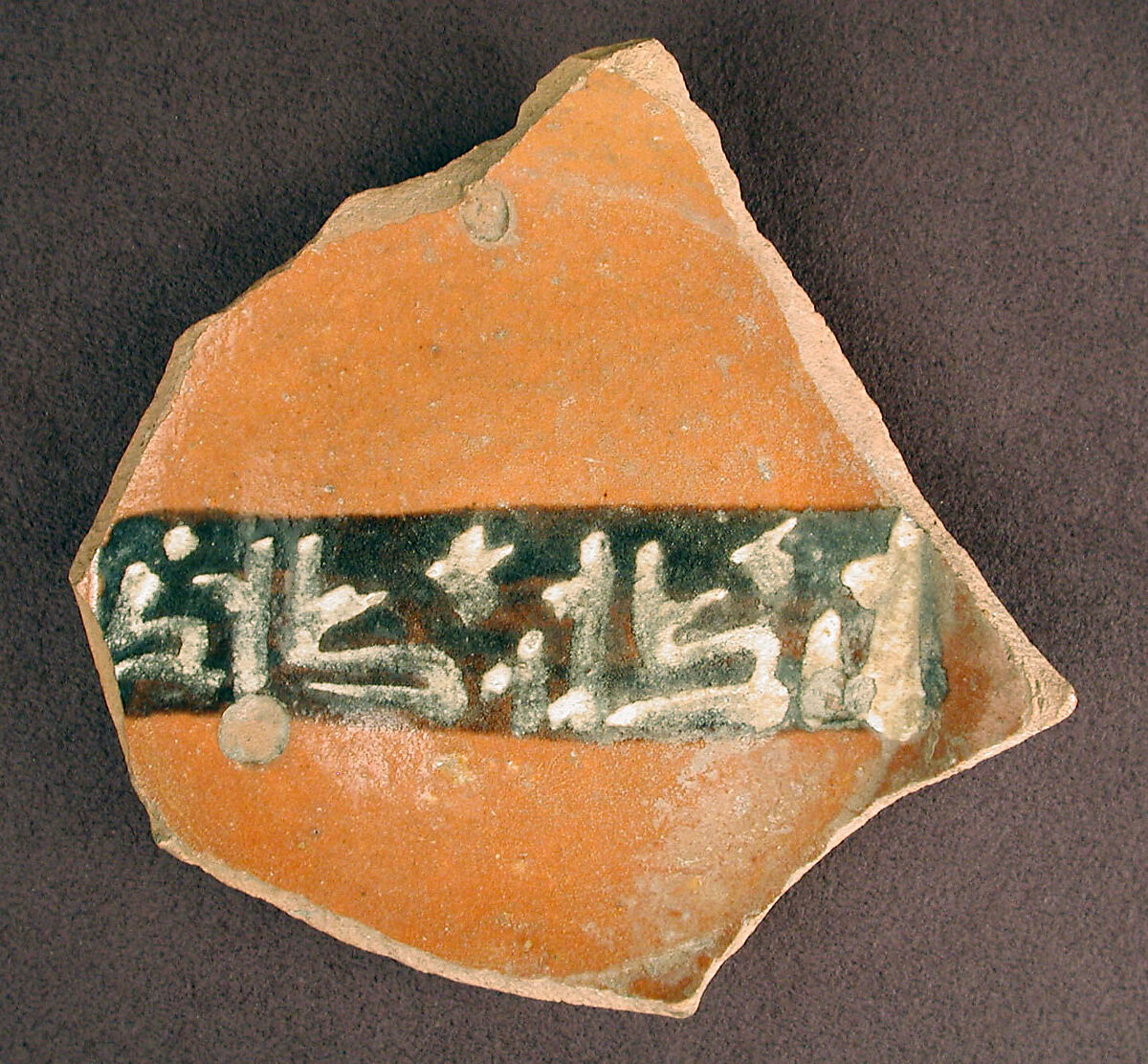 Base of a Vessel with a White Slip Inscription, Earthenware; red slip with polychrome slip decoration under transparent glaze 