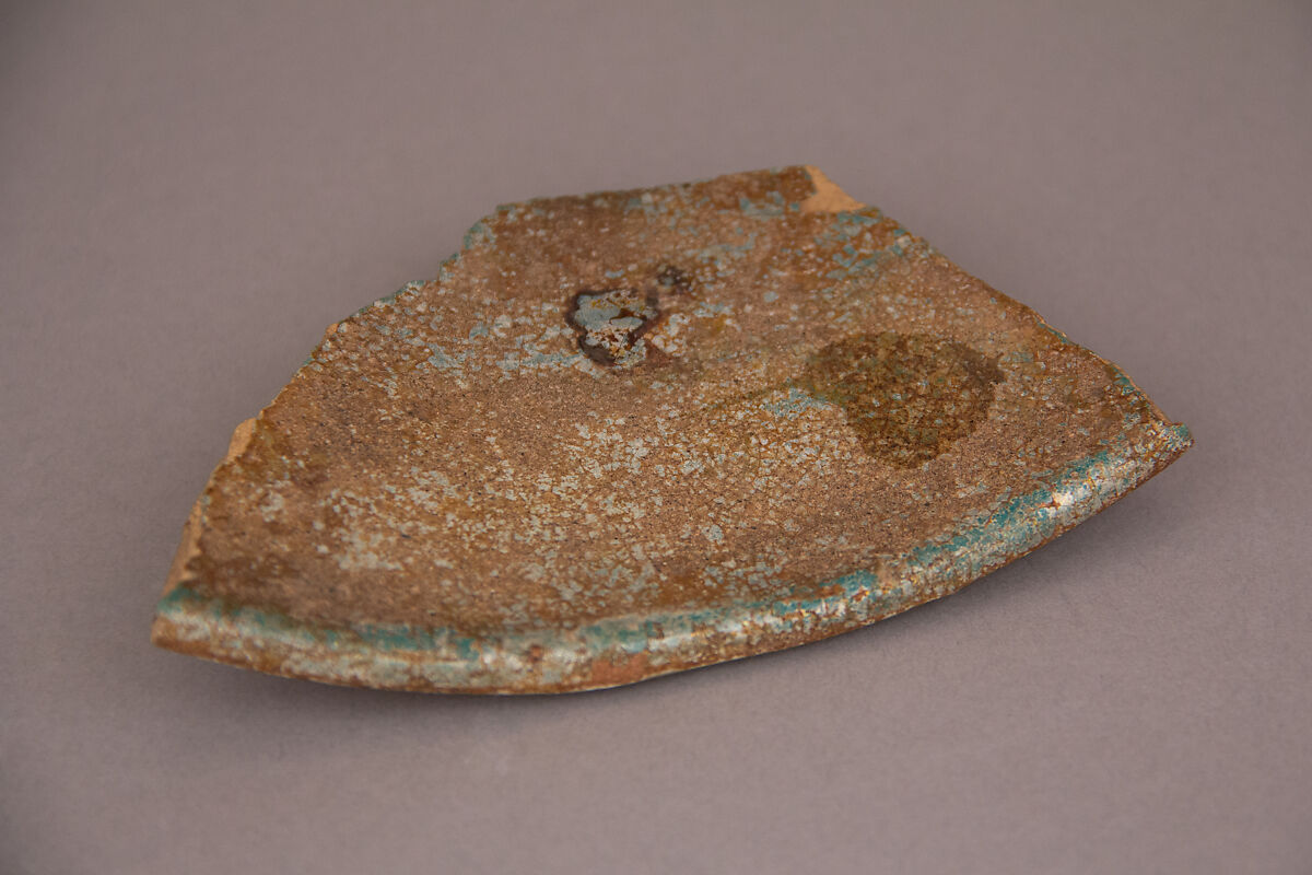 Waster, Earthenware; gritty yellowish body under blue glaze 