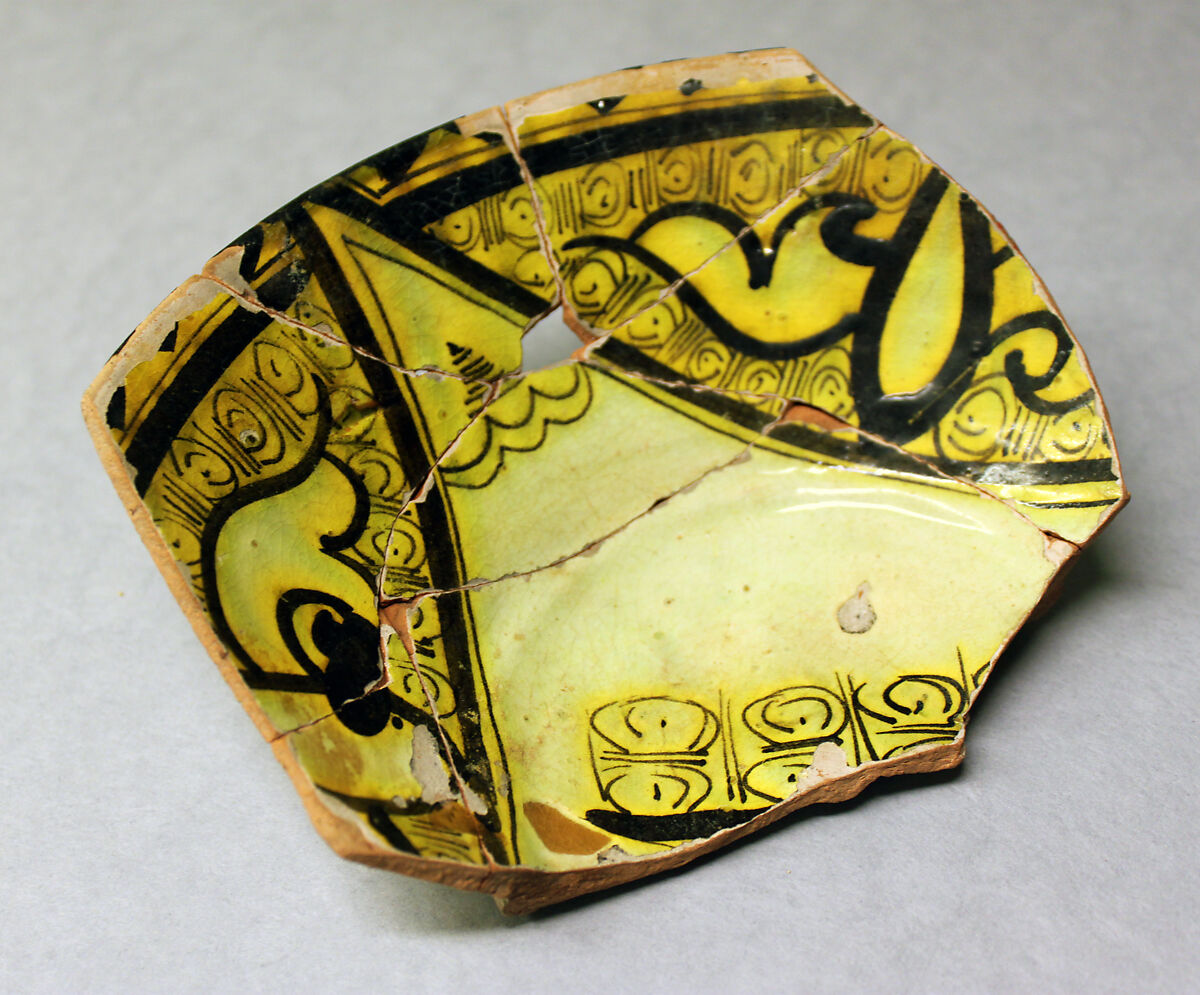 Fragment of a Bowl, Earthenware; reddish body with white slip and black decoration under yellow glaze 