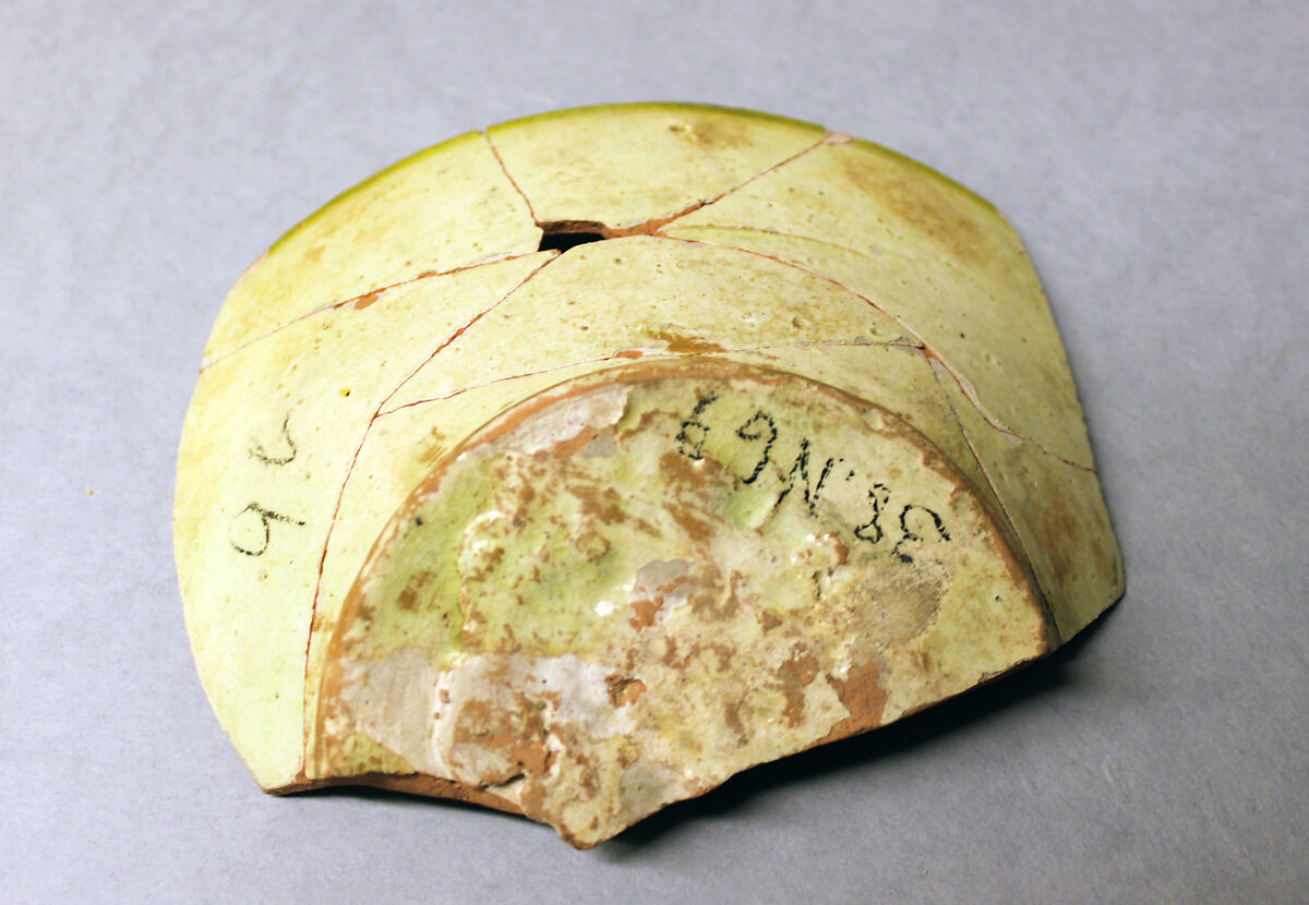 Fragment of a Bowl, Earthenware; reddish body with white slip and black decoration under yellow glaze