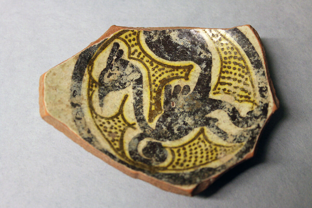 Fragment of a Bowl, Earthenware; white slip, yellow glaze, purplish black and green decoration 