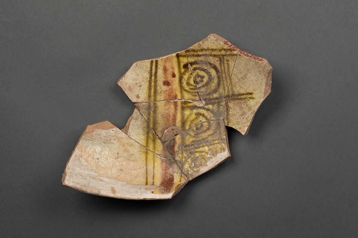Fragment of a Bowl, Earthenware; reddish body, white slip with  yellow-black and red slip painting under glaze 