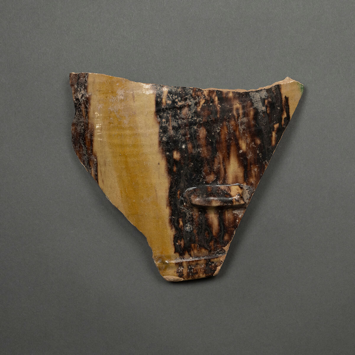 Fragment of a Bowl, Earthenware; purplish black and yellow slip decoration, glazed 