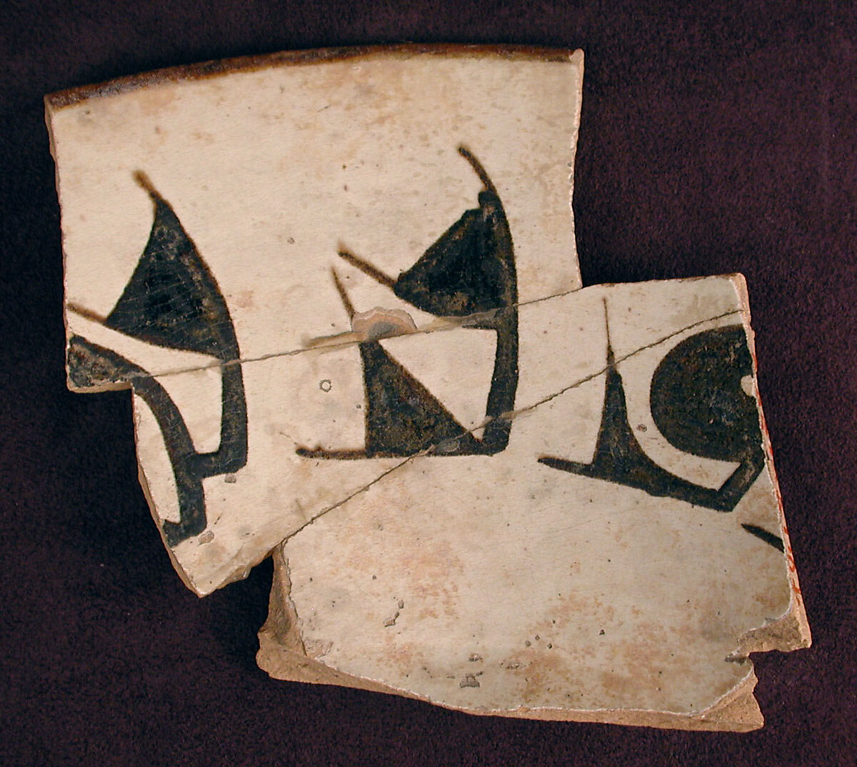 Fragment of a Bowl, Earthenware; white slip with black slip decoration under transparent glaze 