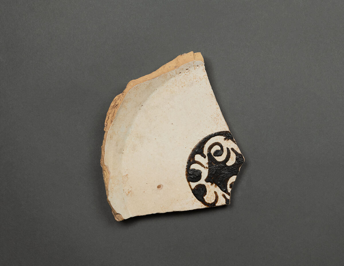 Fragment of a Bowl, Earthenware; yellowish buff body, white slip, brown-black slip decoration under glaze 