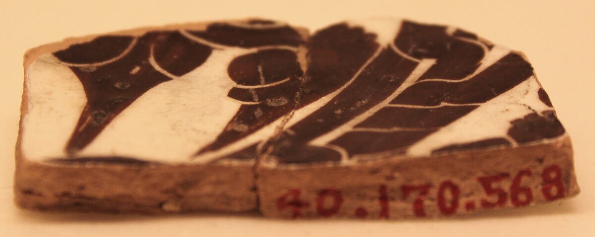 Fragment of a Bowl, Earthenware; buff body, white slip, dark brown slip decoration, sgraffito decoration under glaze