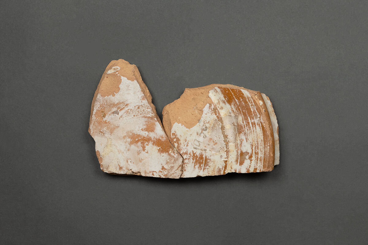 Fragment of a Bowl, Earthenware; reddish buff body, white slip, brown-black slip decoration under glaze