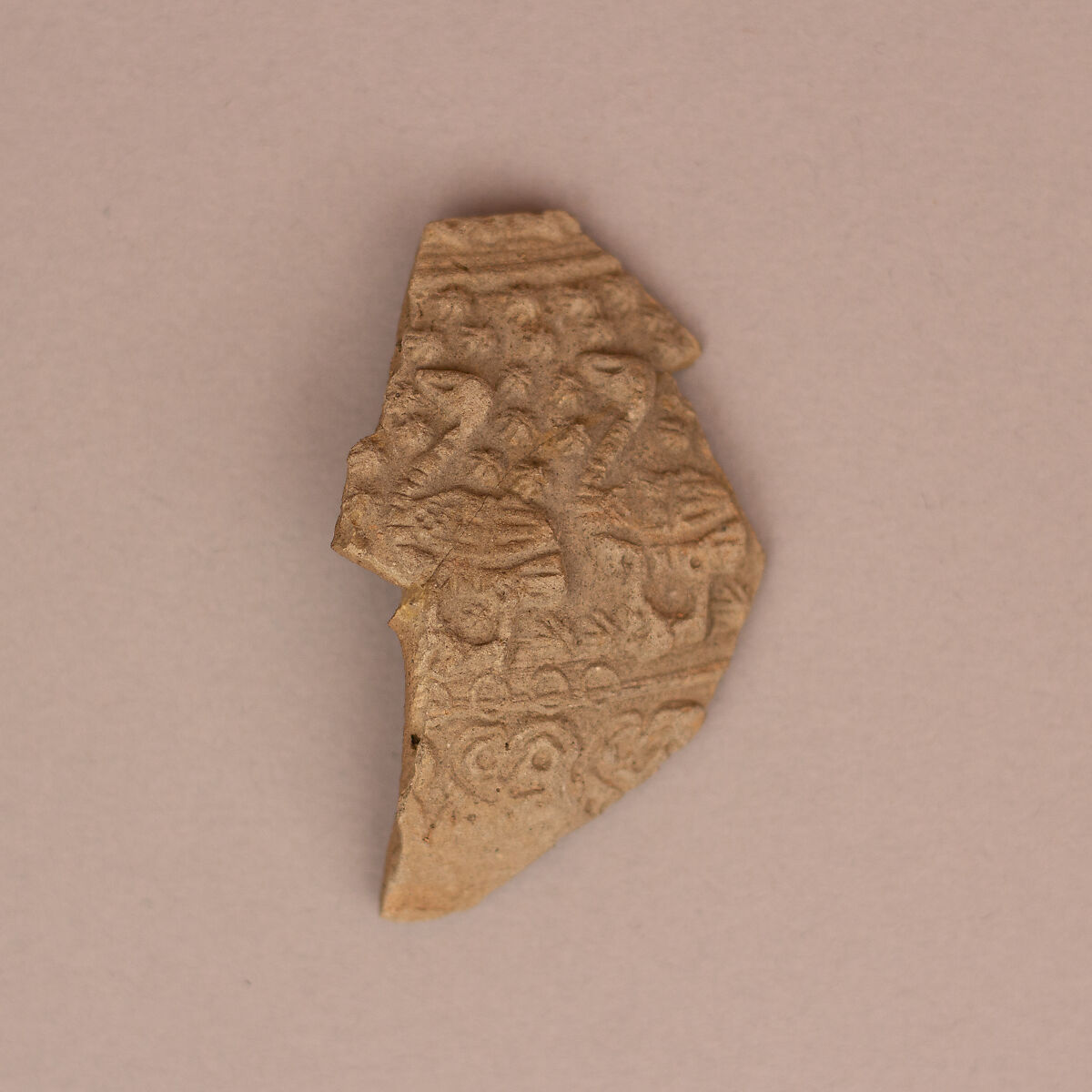 Ceramic Fragment, Earthenware; molded and unglazed 