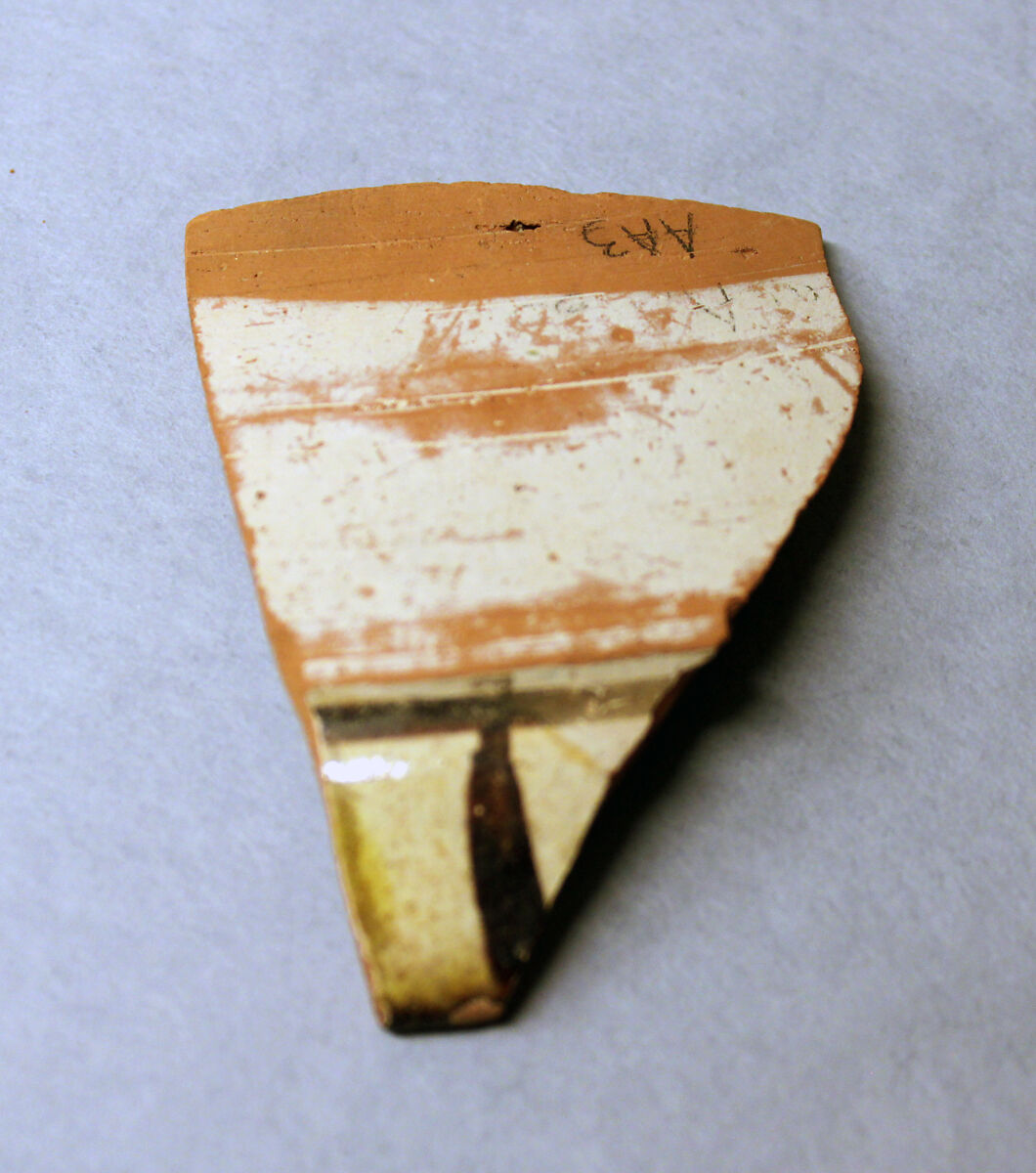 Fragment of a Bowl, Earthenware; red body, white slip, slip decoration in yellow, green and brown-black under glaze