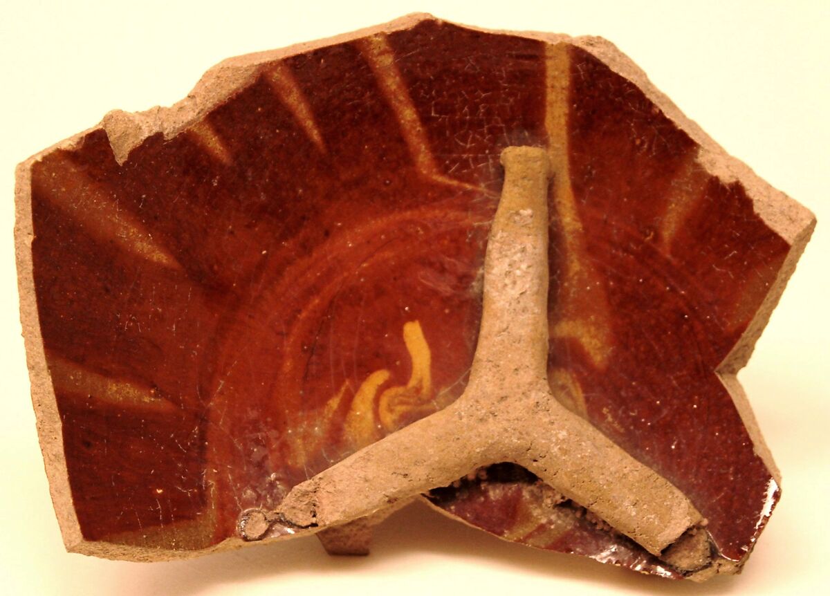 Waster of a Bowl with a Tripod Stuck Inside, Earthenware; gritty buff body, reddish brown and yellow streak decoration 