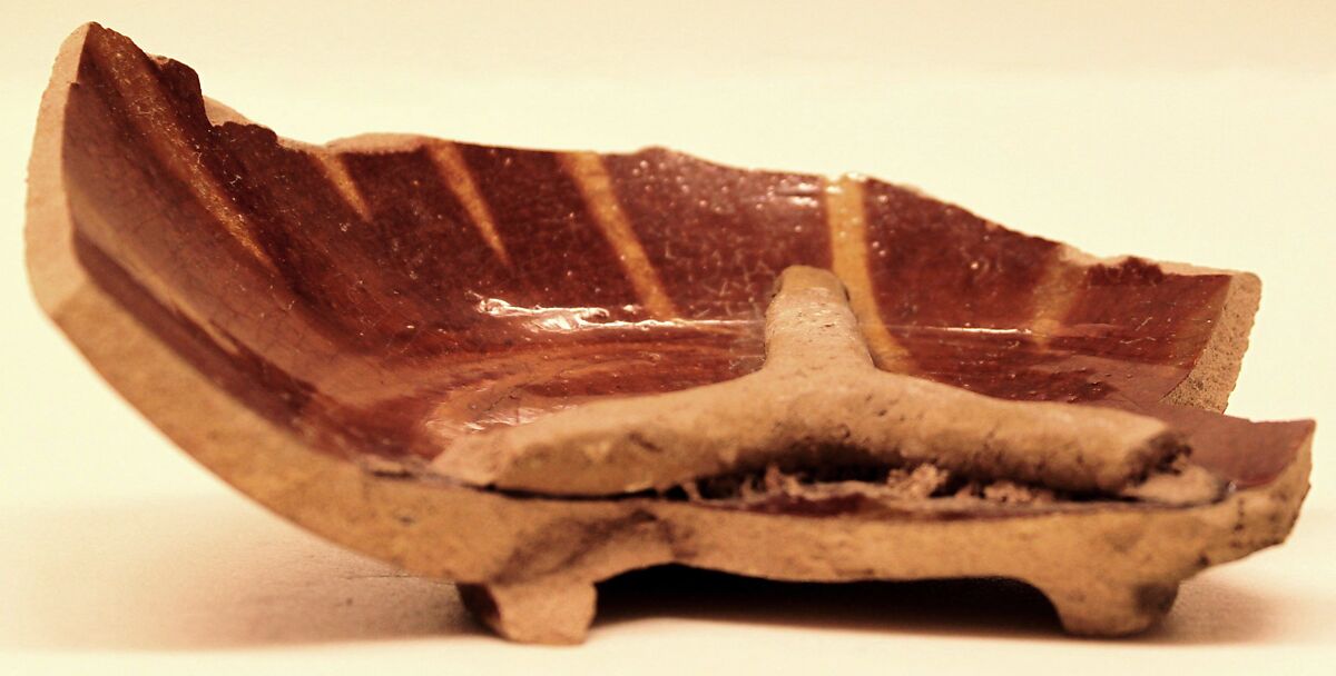 Waster of a Bowl with a Tripod Stuck Inside, Earthenware; gritty buff body, reddish brown and yellow streak decoration