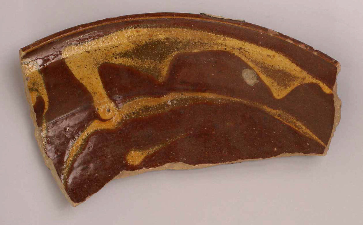 Fragment of a Dish, Earthenware; gritty buff body, brown and yellow streak decoration under glaze 