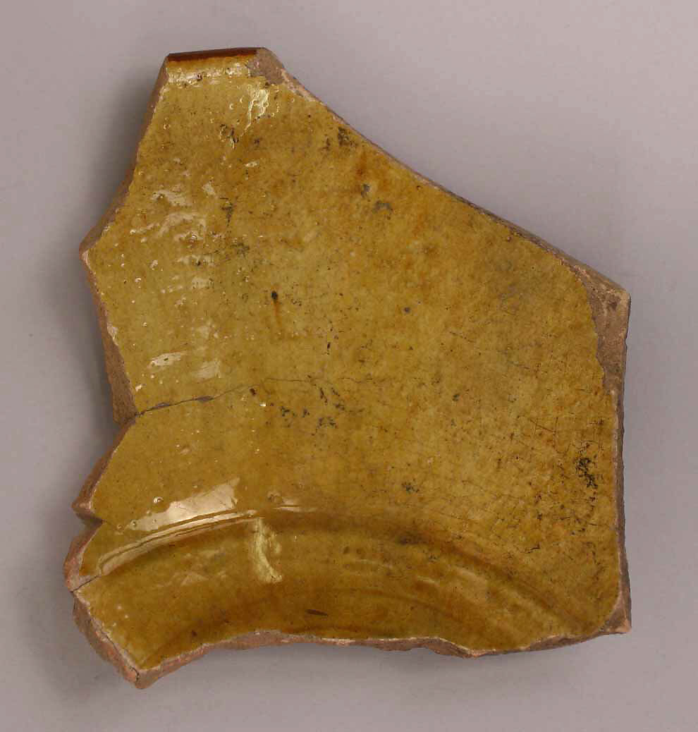 Fragment of a Bowl, Earthenware; gritty buff body, yellow and red-brown decoration, glazed 